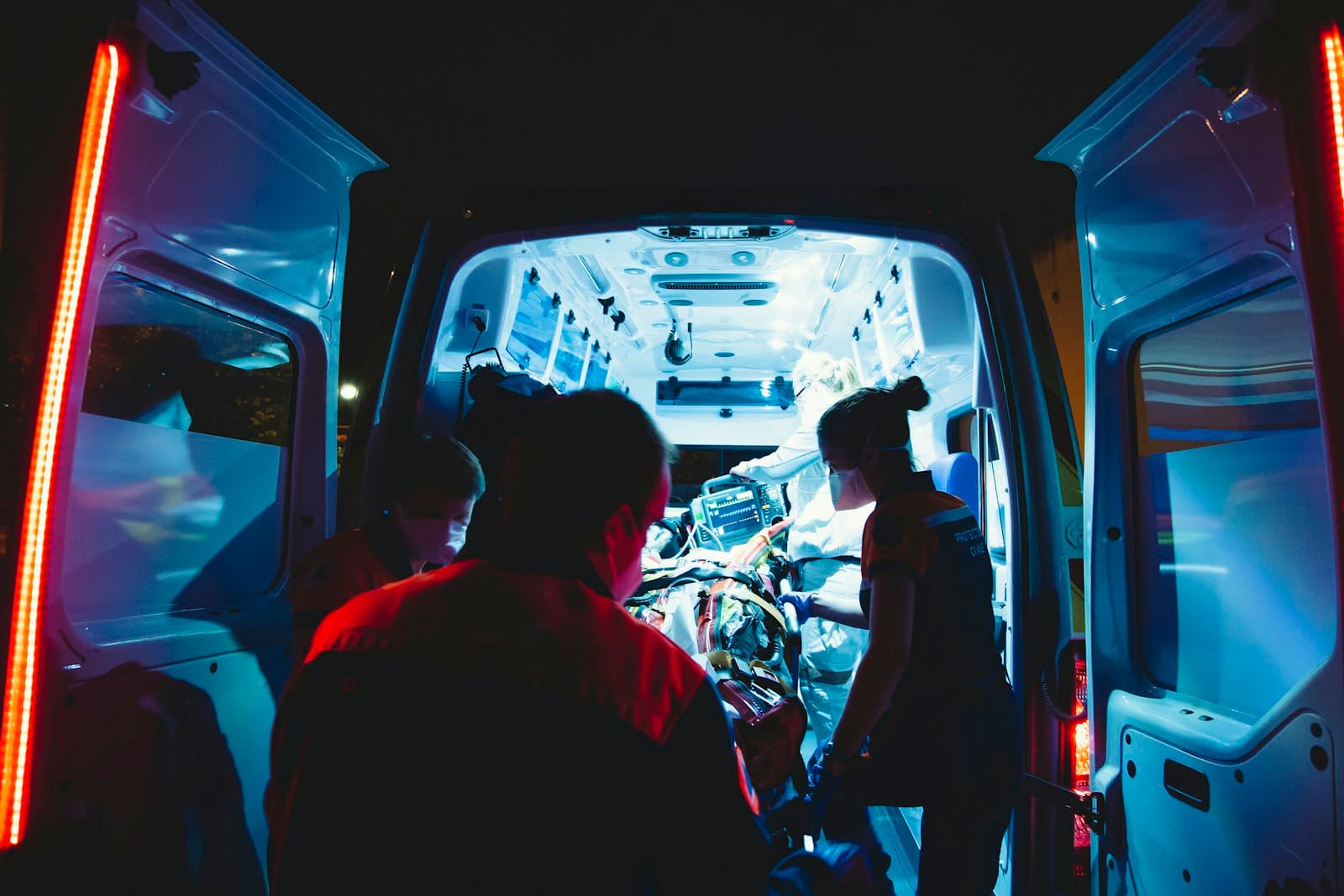 Paramedics attending to a patient inside an ambulance