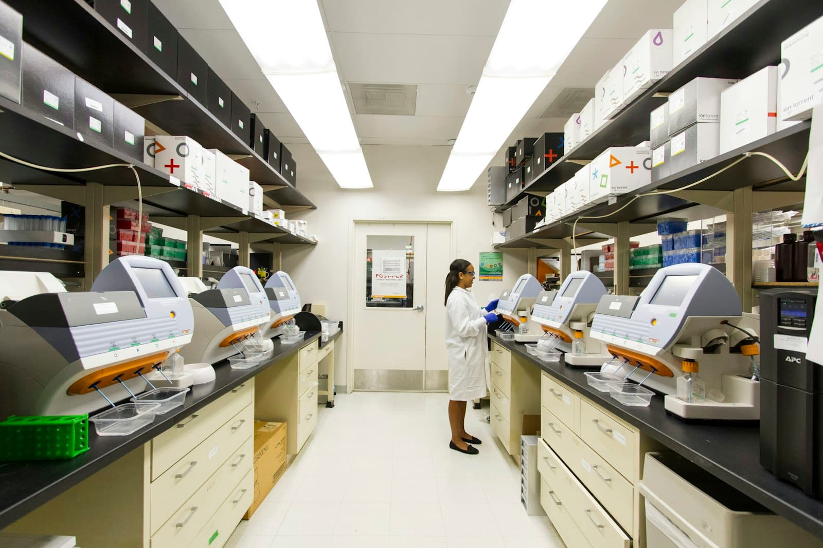 A clean, well-lit clinical laboratory with analysers on the benches